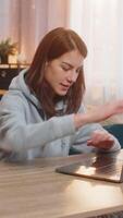 Young woman freelancer closing laptop stretches back and looks joyfully finalizing the successful end of workday and readiness to relax. Caucasian girl relaxing taking a break up sitting at table video