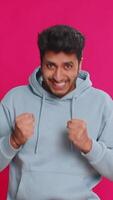 Oh my God, Wow. Excited amazed winner man raising hands in surprise looking at camera with big eyes, shocked by sudden victory celebrating success achievement good news. Guy on pink background video