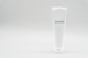 Minimal White Toothpaste Tube with Copy Space. White toothpaste tube with simple TOOTHPASTE text. dental care, oral hygiene, beauty, cosmetic products, health. photo