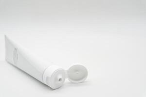 Minimal White Toothpaste Tube with Copy Space. White toothpaste tube with simple TOOTHPASTE text. dental care, oral hygiene, beauty, cosmetic products, and personal care branding. photo