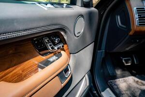 Indulge in the experience of opulence by stepping inside a luxurious car interior that showcases rich wood accents alongside modern controls, seamlessly blending elegance with the latest innovation photo