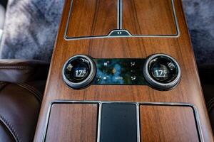 Luxury Vehicle Interior This stunning interior features a highend climate control system that ensures optimal comfort, beautifully complemented by an elegant wood finish that exudes sophistication photo