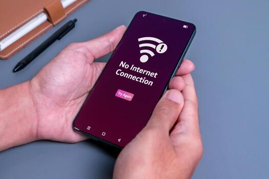 No internet access or bad connection concept. Man using smartphone with notification no internet connection. photo