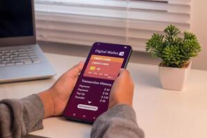 E-wallet transaction, digital wallet or online payment concept. Woman using digital wallet on her smartphone to pay online. photo