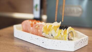 Carefully Plating Sushi at Home with Hand Adding Ginger Garnish for a Beautiful Homemade Meal video