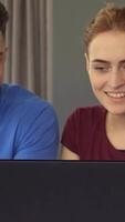 Young professionals share laughter and creativity at a laptop video