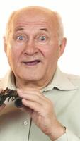 Elderly man peering through binoculars with a look of astonishment video
