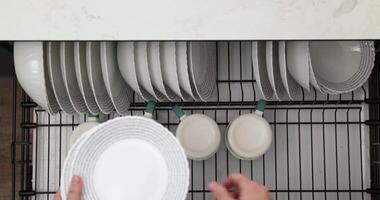 Preparing to Set the Table With a Simple White Plate and Hands in a Modern Kitchen video