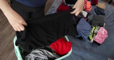 Sorting Laundry and Organizing Clothes for Efficient Home Management video