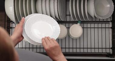 Organizing Clean Dishes in the Kitchen After a Busy Day of Cooking and Serving video