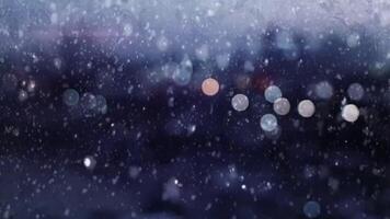 Winter Snowfall Over Cityscape with Bokeh Lights at Night Abstract Background video