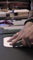 A person cutting a piece of paper with a pair of scissors video
