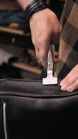A person is using a razor to shave a piece of leather video