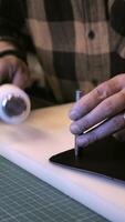 A person is using a tool to make a piece of paper video