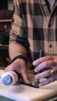 A man is using a tool to make a piece of wood video