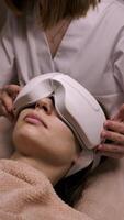 SPA with OCURELAX smart massager of the transorbital zone around the eyes. Cosmetologist use device relieves visual fatigue, refreshes the look and improves blood circulation in beauty salon video