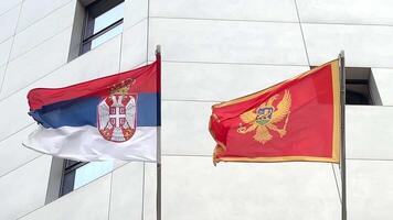 National flags of Serbia and Montenegro flutter in the wind video