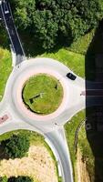 An aerial view of a circular road with a car driving through it video