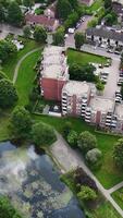 An aerial view of a residential area with a pond video