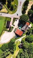 Aerial view of a farm with a house, barn and a car video