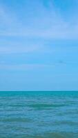 Vertical sea view wide beautiful nature ocean wave and blue sky background in day time video