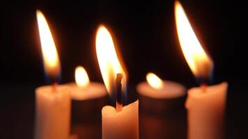 Bright candle flames glowing in darkness, enhancing the sense of warmth, peace, and tranquility. video