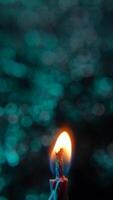 Vertical shot of birthday candles burning on blue bokeh background video
