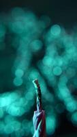 Vertical shot of Igniting a Candle with a wooden matchstick on Soft Blue Bokeh Background. Close-up of candle wick detail video