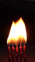 Four candles burning brightly in the dark, showcasing warm light and soft ambiance. video