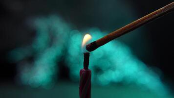 Igniting a Candle with a wooden matchstick on Soft Blue Bokeh Background. Lighting birthday candles video