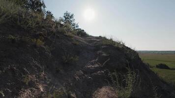 A person walking up a hill on a sunny day video