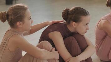 Close-up of ballerina stretching legs in class video