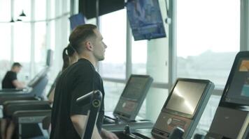 Man and woman doing fitness exercises in gym. Strength, endurance and training focus in modern fitness center 62 video