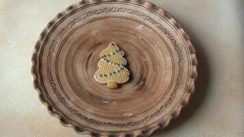 Hand pus Gingerbread cookies with icing on a plate. Christmas tree. deer, house and mitten. Sweet winter food. video