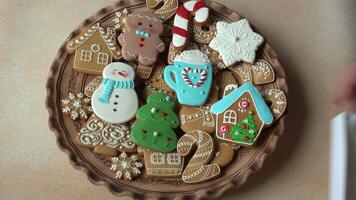 Gingerbread cookies with icing on a plate. Christmas food. Gingerbread man. Top view set heap video