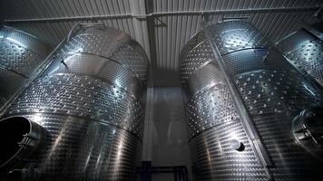 Large steel barrels for wine fermentation. Wine production plant. Steel wine distilling tanks. video