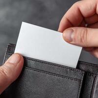 A person holding a business card in their wallet photo