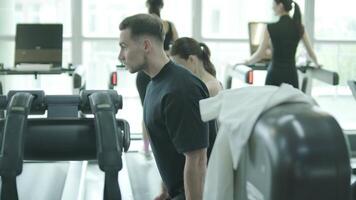Man and woman doing fitness exercises in gym. Strength, endurance and training focus in modern fitness center 44 video