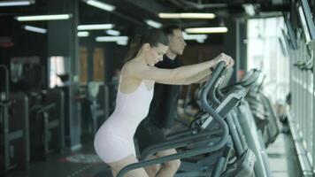 Man and woman doing fitness exercises in gym. Strength, endurance and training focus in modern fitness center 6 video