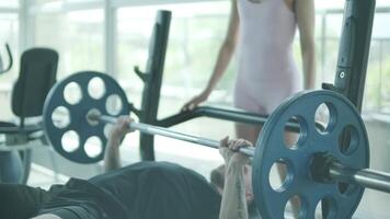 Man and woman doing fitness exercises in gym. Strength, endurance and training focus in modern fitness center 10 video
