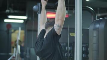 Man and woman doing fitness exercises in gym. Strength, endurance and training focus in modern fitness center 22 video