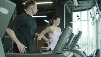 Man and woman doing fitness exercises in gym. Strength, endurance and training focus in modern fitness center 58 video