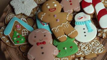 Gingerbread cookies with icing on a plate. Christmas food. Gingerbread man. Traditional sweet baking video