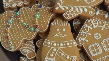 Gingerbread cookies with white icing. Christmas food. Gingerbread house. Top view video