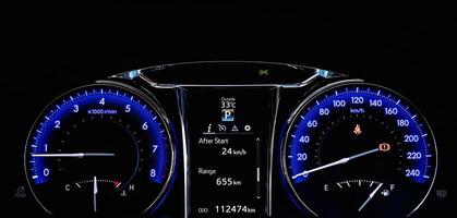 Close up of car dashboard modern Instrument automobile panel with Odometer, speedometer, tachometer, fuel level. photo