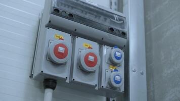 Industrial sockets and plug on distribution board. Factory site electricity video