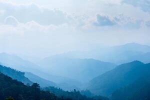 Mountain lanscape in fog, mountain ridge and valley with morning sky landscape. photo