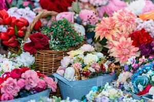 Bouquet artificial flowers in flower vase and baskets for interior design and decoration artificial flower fabric rose bouquet background. photo