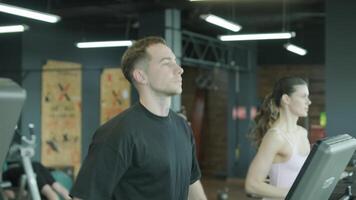 Man and woman doing fitness exercises in gym. Strength, endurance and training focus in modern fitness center 68 video