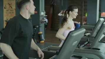 Man and woman doing fitness exercises in gym. Strength, endurance and training focus in modern fitness center 59 video